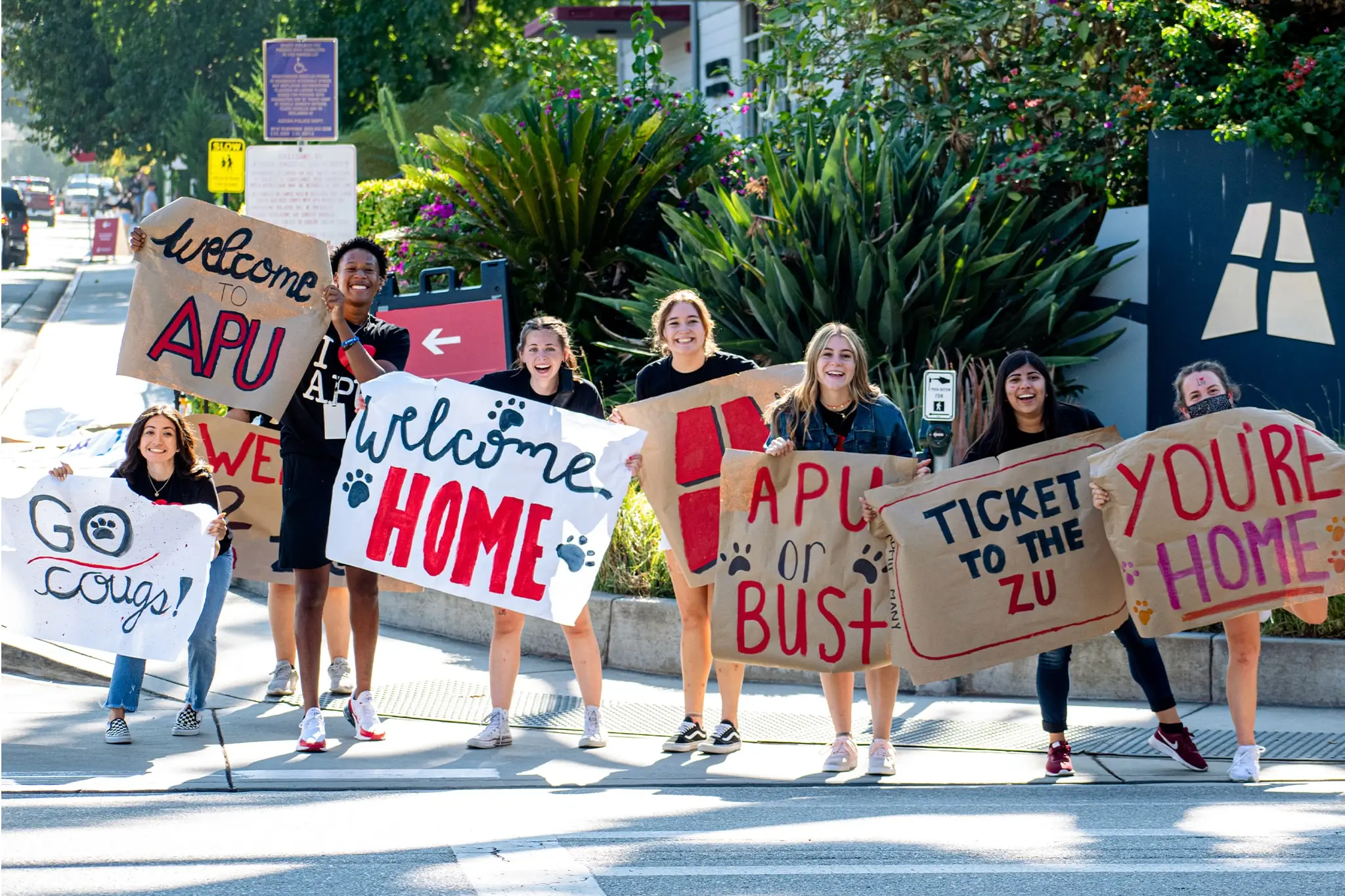 Students holding welcoming posters