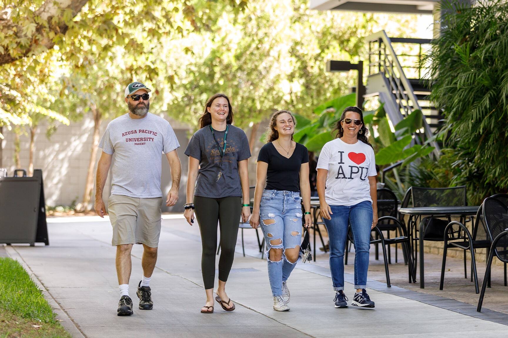 apu student and family walking on campus during tour
