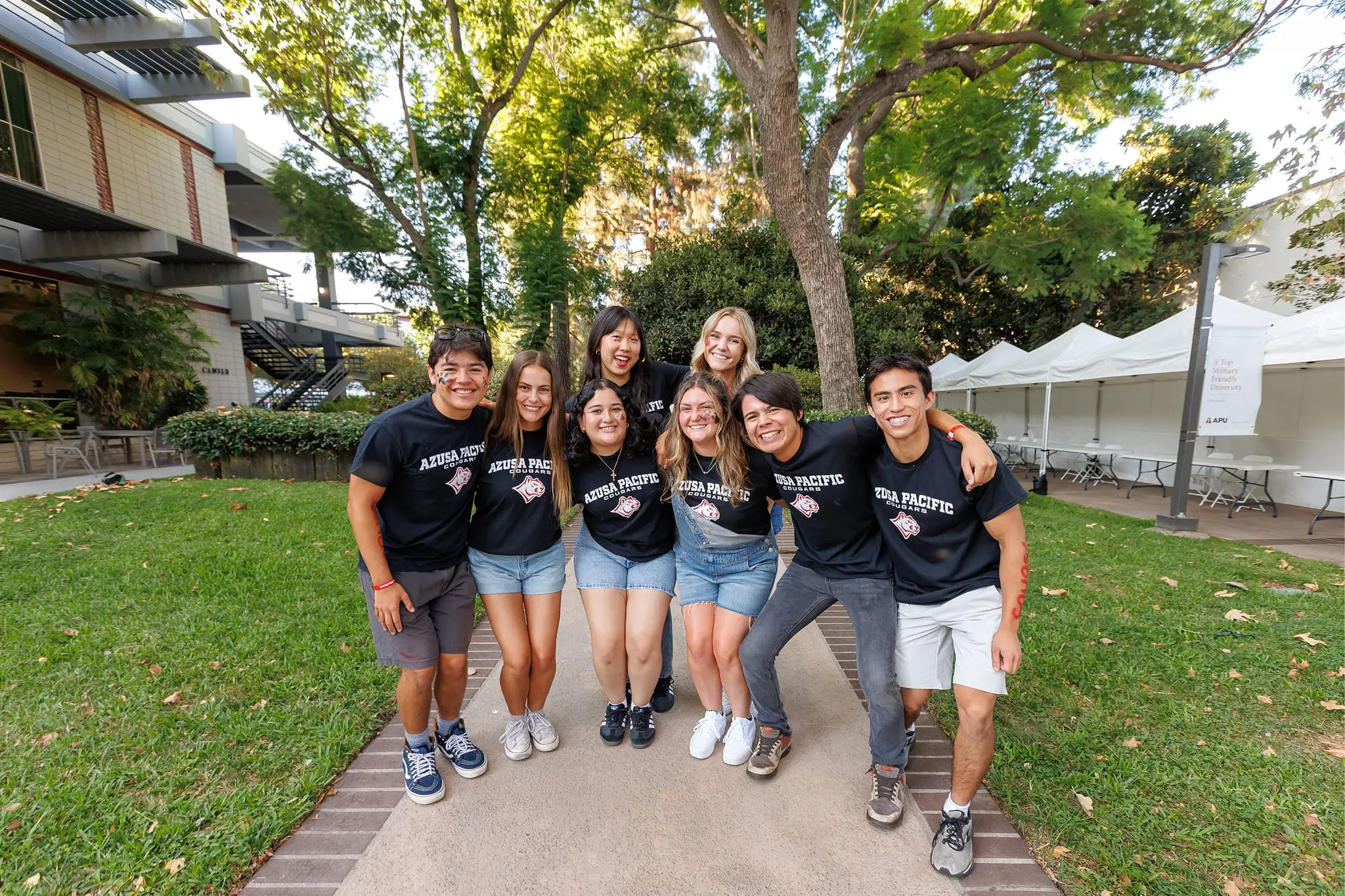 students smiling with black t-shirts