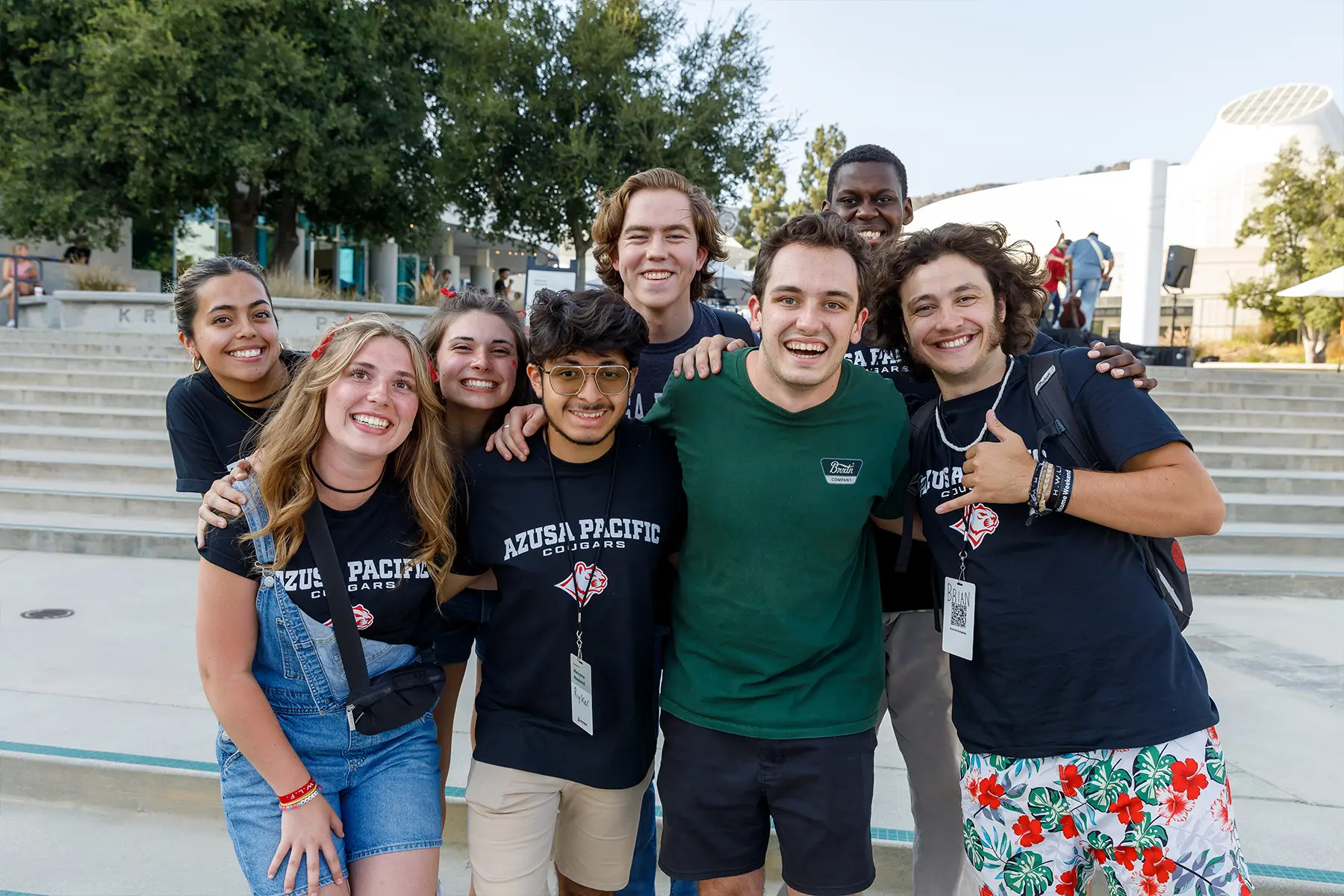 students at west campus hunging and smiling for a picture. All wearing black apu t-shirts
